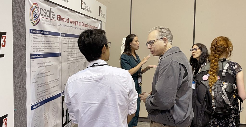 Summer 2022 REU interns David Chu (front, left) and Katarina Maier (back, left) presented their REU research project at the International Association for Identification (IAI) Annual Educational Conference.