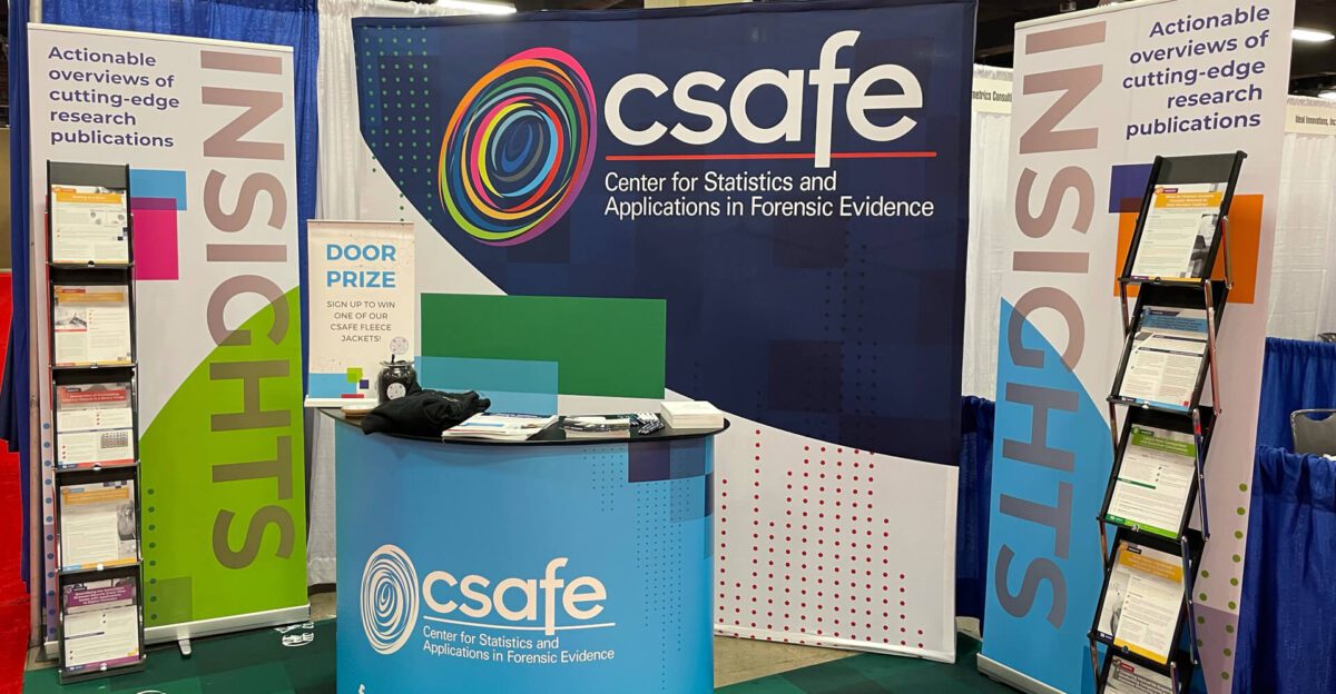 CSAFE booth with brochures, a banner, and a sign for a door prize at a conference.