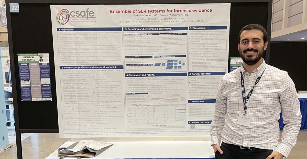 Man stands beside a scientific poster about forensic evidence systems at a conference or event.