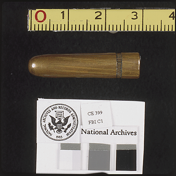 A bullet next to a measuring tape and a National Archives label with color and grayscale swatches.