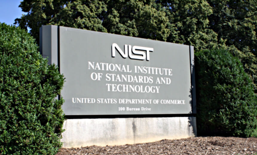 NIST sign at the National Institute of Standards and Technology entrance, surrounded by bushes.